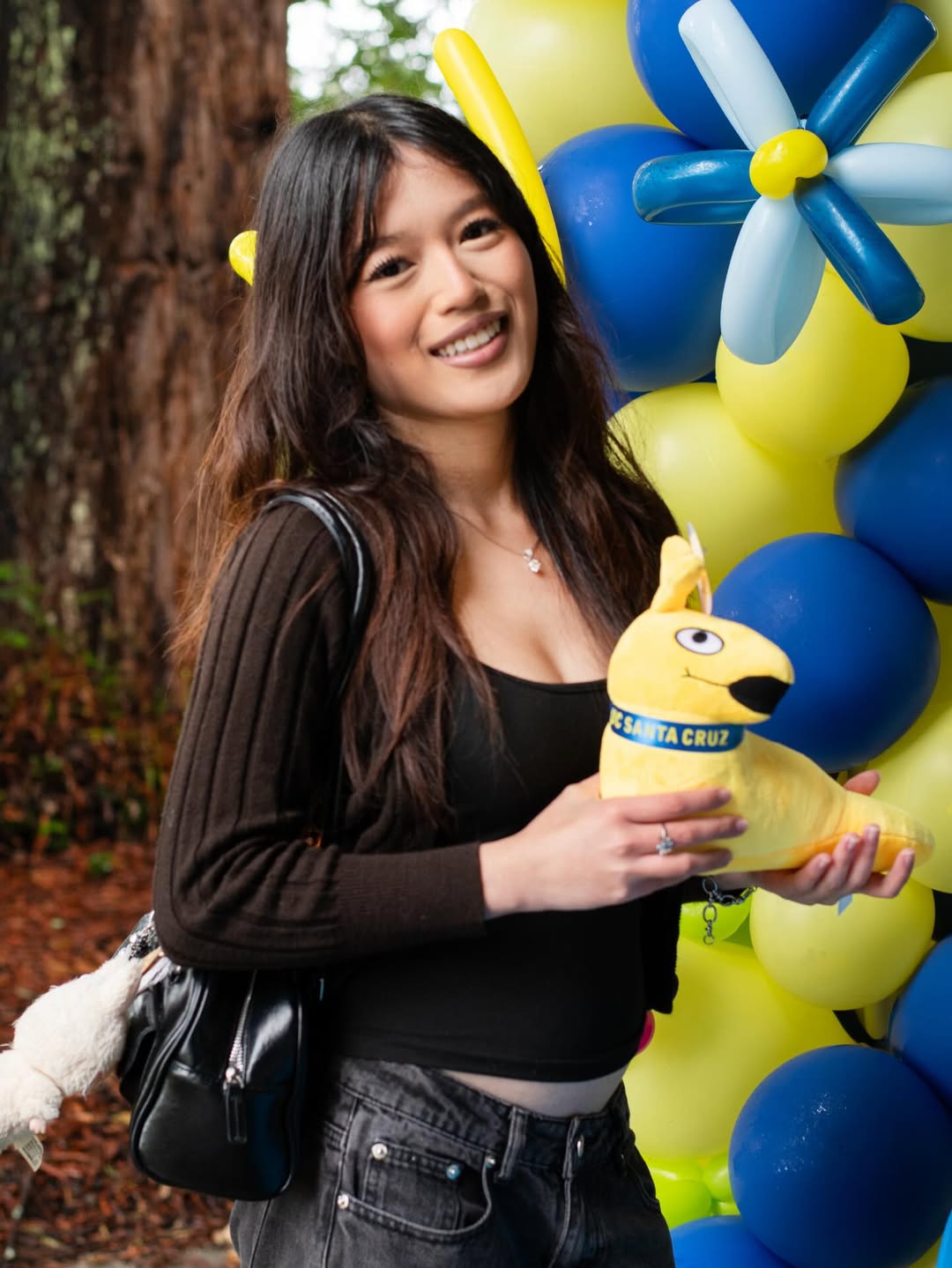 Accepted student poses with a stuffed slug at BSD