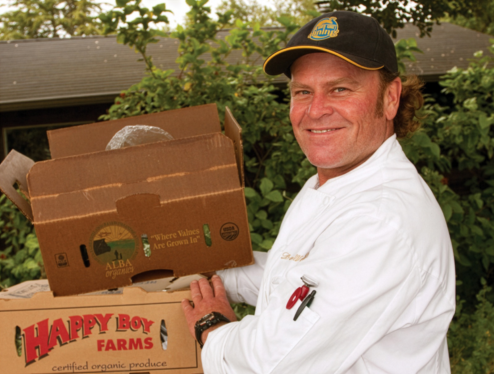 Dennis Wake in chef uniform preparing food for a campus event