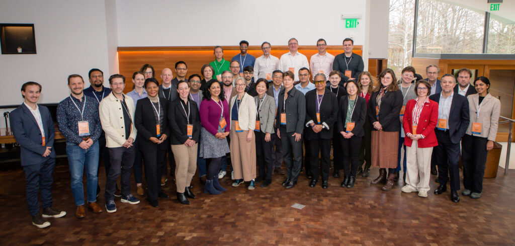 A group of people smile for at the research workshop.