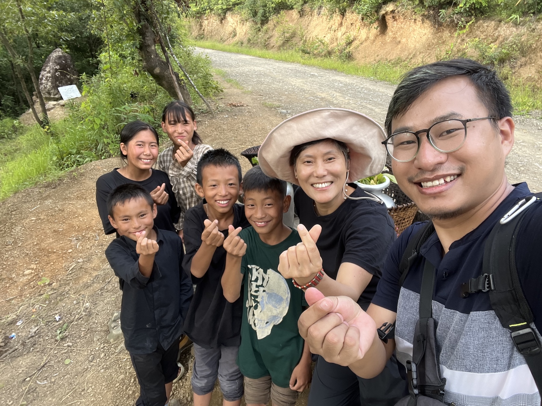 Selfie of researchers with village children, all smiling