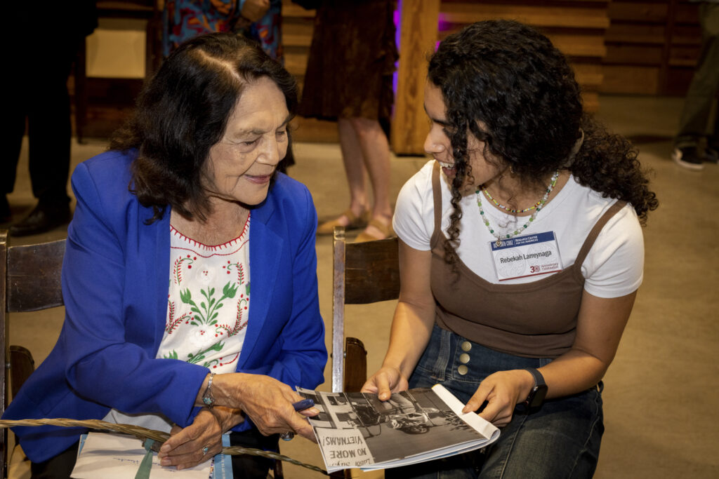 Dolores Huerta signs a program for UCSC student.