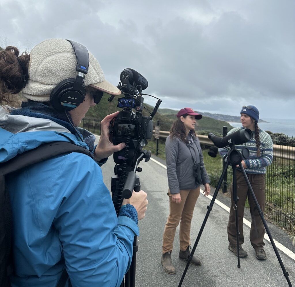 Video podcasters interviewing subject outdoors