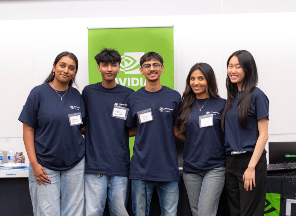 Five smiling students wearing matching shirts