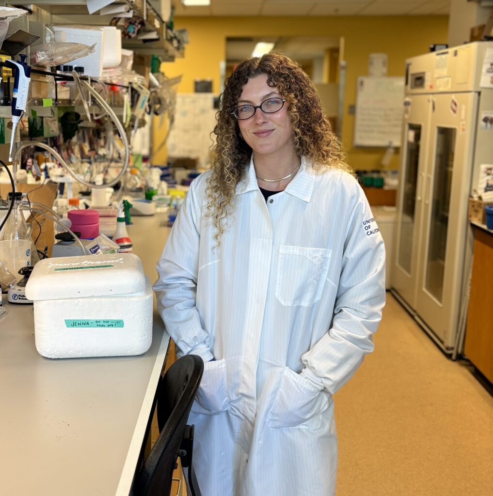 Jenna Myers in the lab wearing a white lab coat