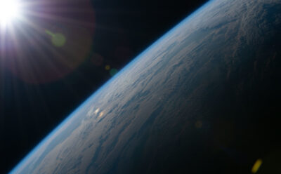 View from space as the Sun begins illuminating Earth’s surface.