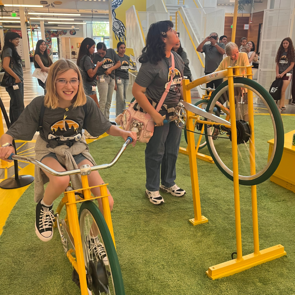 A GIE participant rides a bike at Google