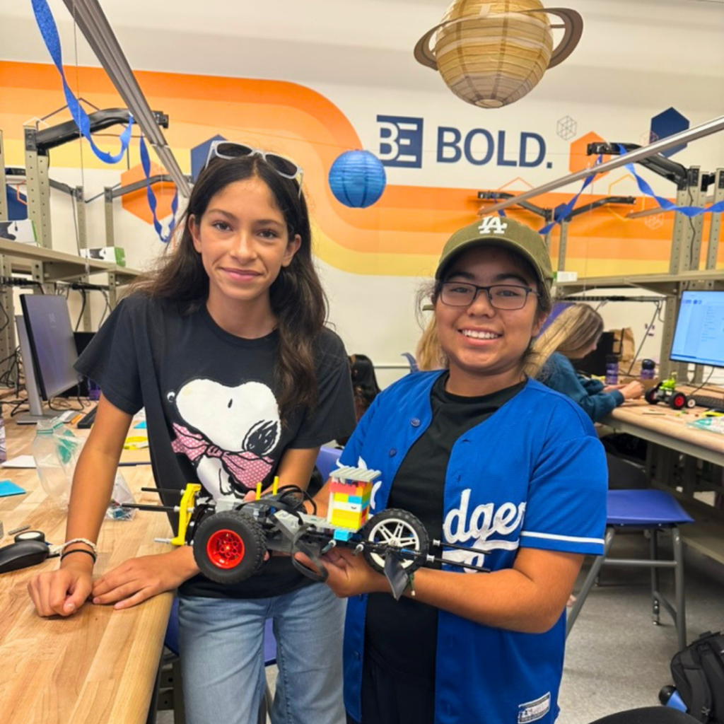 Two GIE participants hold a robot at Baskin Engineering