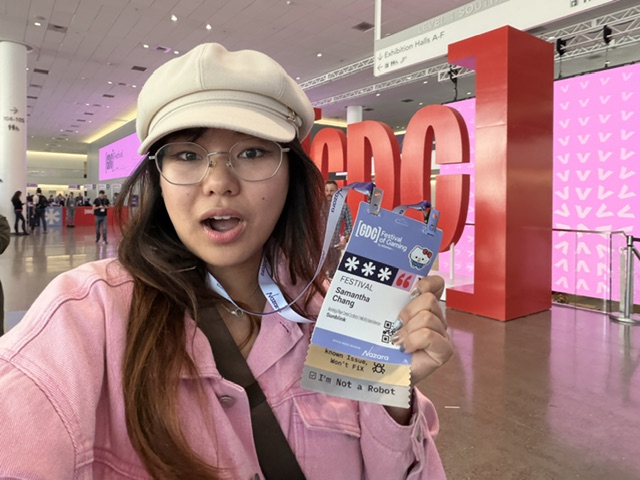 Samantha Chang holds up badge at a gaming convention.