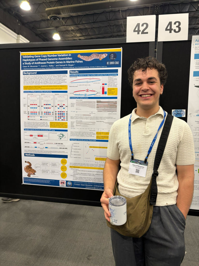Owen Moosman stands in front of a presentation board.