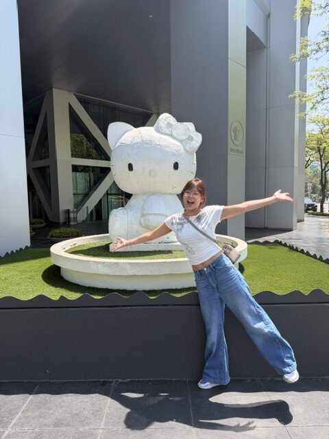 Samantha Chang poses in front of a Hello Kitty statue