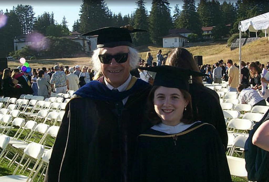 Lúcia Soares with Professor Michael Warren at UC Santa Cruz graduation in cap and gowns.