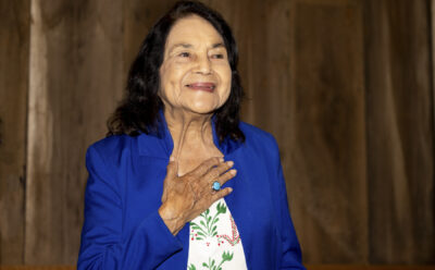 Dolores Huerta holds her hand over her heart