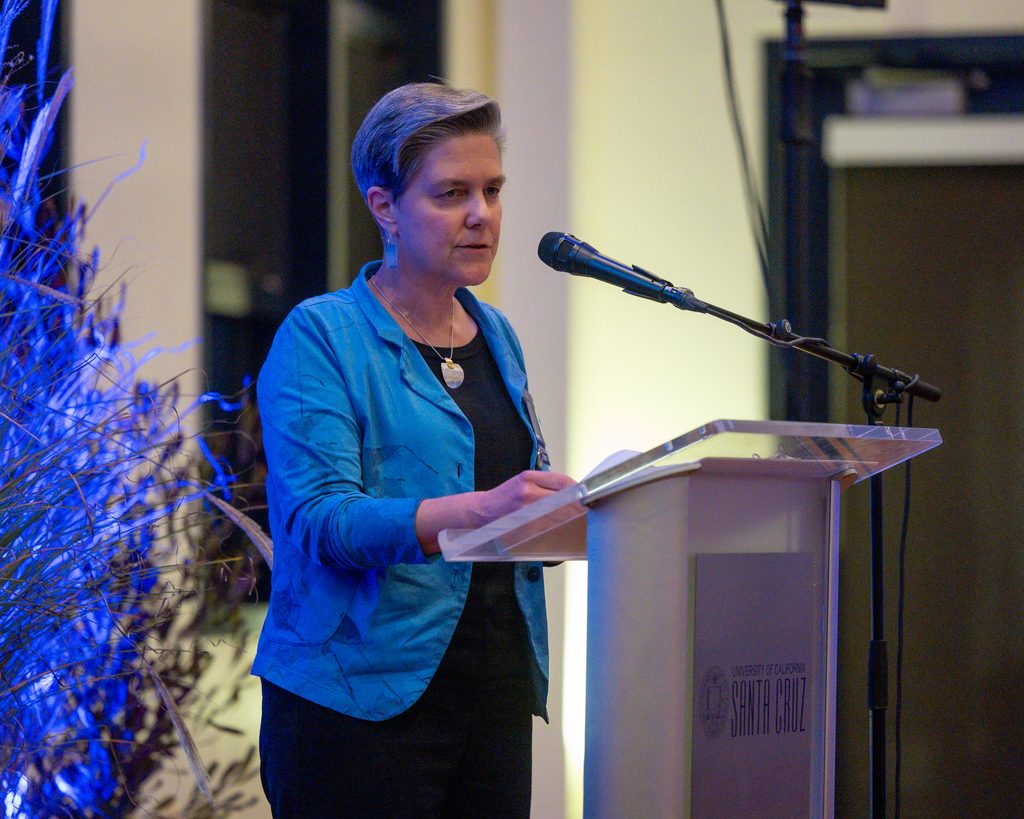 Melinda Aldrich accepts her award at the podium