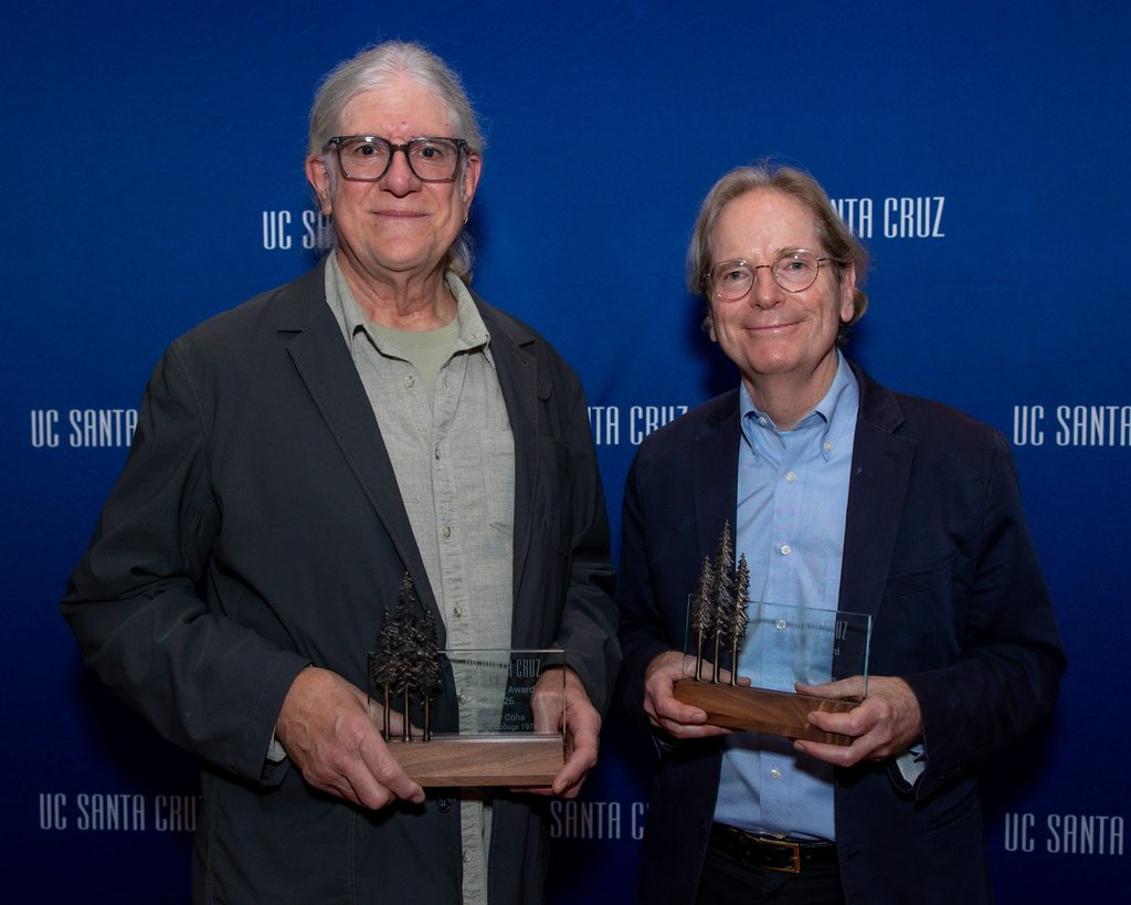 Peter Coha and Jim Gunderson hold their award plaques at the UC Santa Cruz backdrop