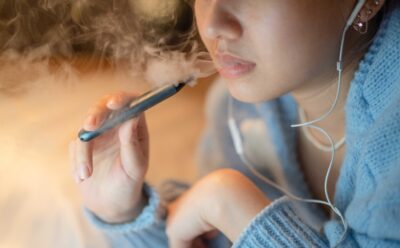 Young woman vaping an electronic cigarette
